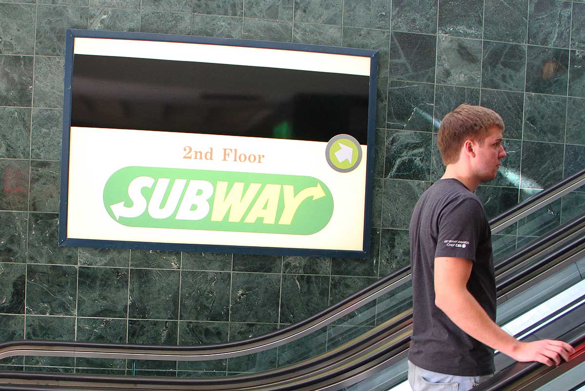 UP: A man rides the escalator to the second floor of the Third Street Promenade food court. (Daniel Archuleta daniela@www.smdp.com)