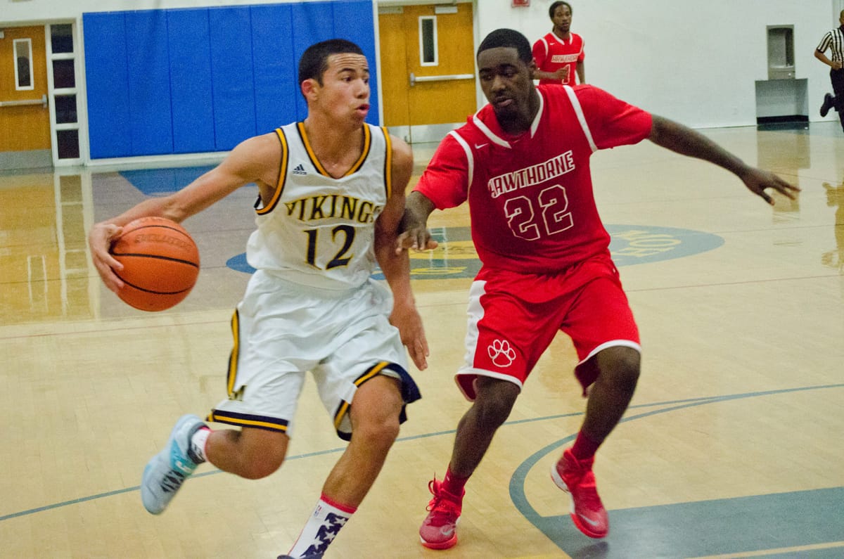 DRIVING: Santa Monica High School's Chris Johnson dribbles past a Hawthorne defender Wednesday night at Samohi. The Vikings went on to win the Ocean League game, 61-45. (Paul Alvarez Jr. editor@www.smdp.com)