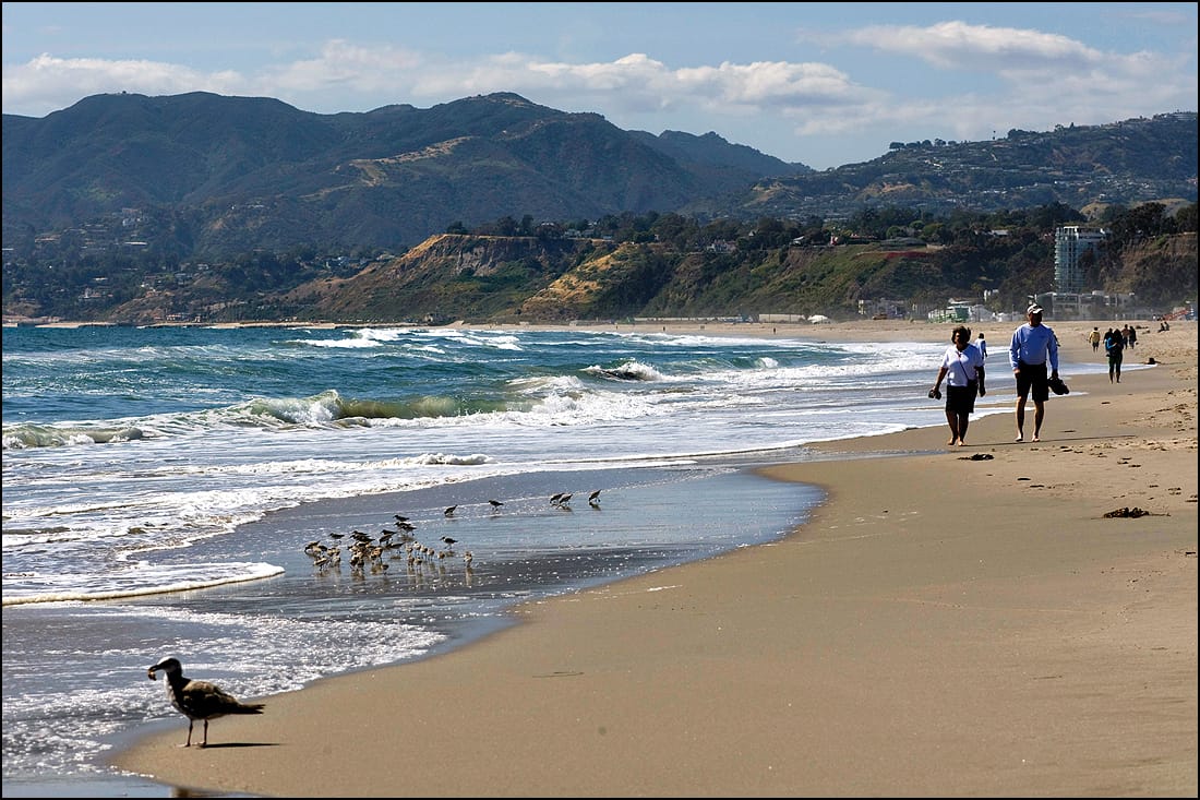 People walk along Santa Monica Beach. (File photo)