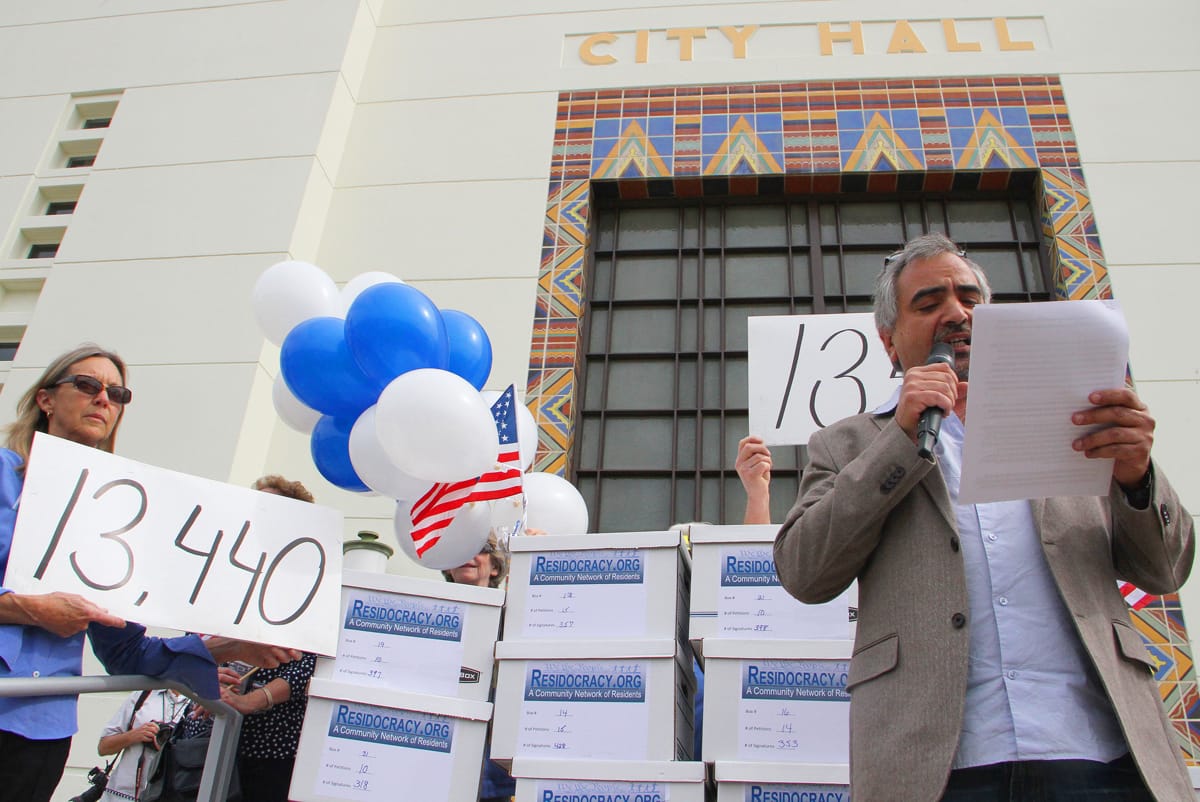 Armen Melkonians, founder of the Residocracy movement, speaks to a crowd of supporters gathered outside of City Hall on Tuesday. The group was there to drop off signatures calling for a referendum against a City Council-approved development. (Daniel Archuleta daniela@www.smdp.com)