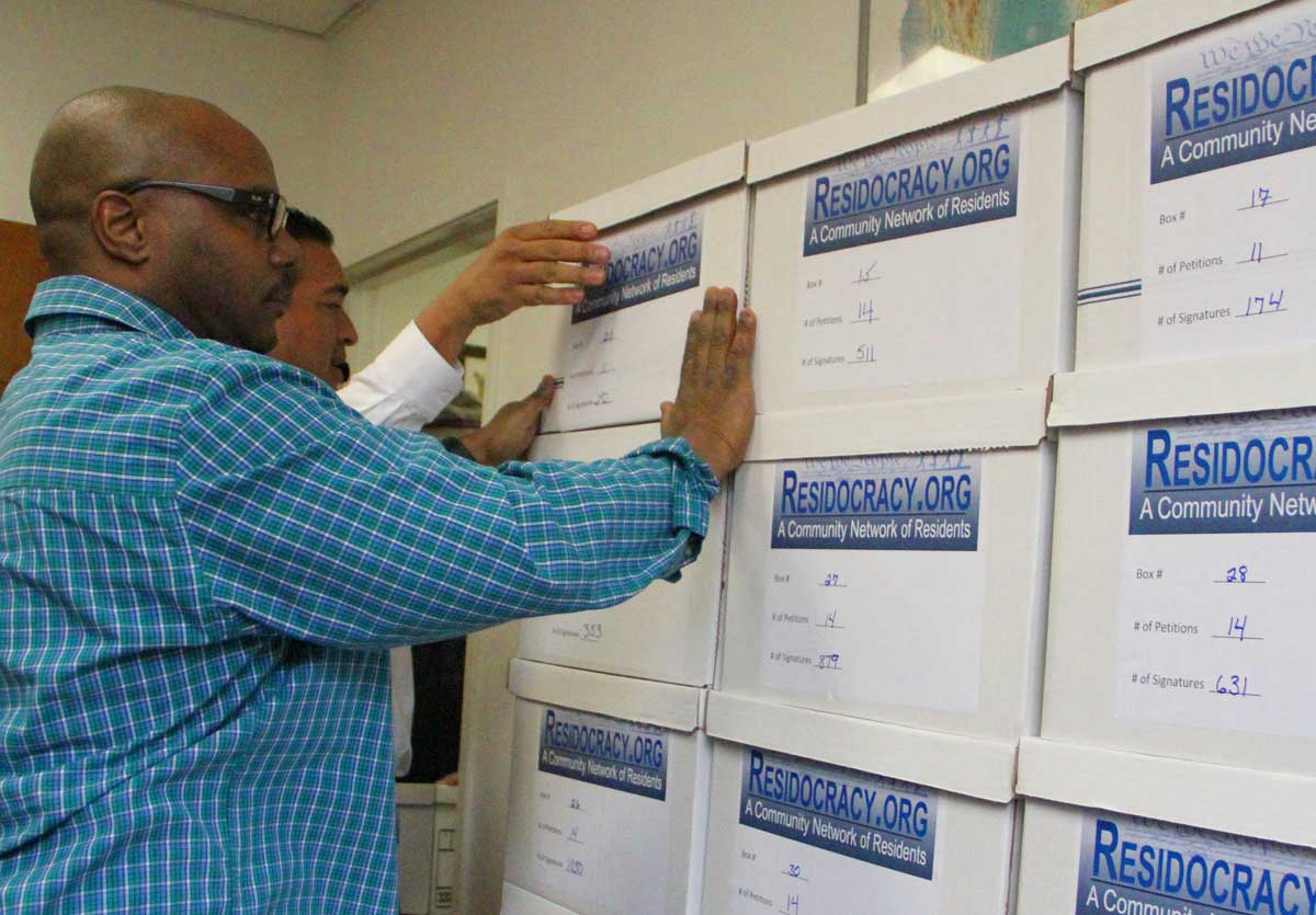LOTS: The city clerk's staff stacks boxes full of referendum petitions at City Hall on Tuesday. (Daniel Archuleta daniela@www.smdp.com)
