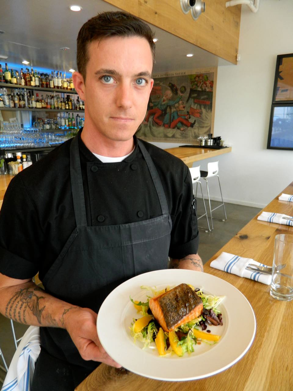 Joseph Mitchell, an accomplished chef who has worked in top seafood restaurants on the East Coast and five years at Food TV Network chef Bobby Flay's Mesa Grill in Caesar's Palace, Las Vegas, with his signature crispy skin salmon on a bed of citrus segments and balsamic dressed salad. (John Blanchette editor@www.smdp.com)
