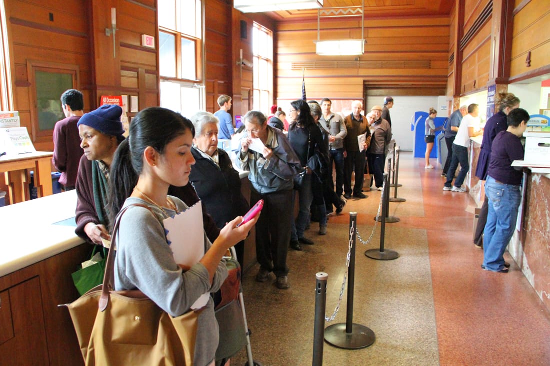 A line of people wait for service at the post office on Fifth Street on Tuesday. (Photo by Daniel Archuleta)