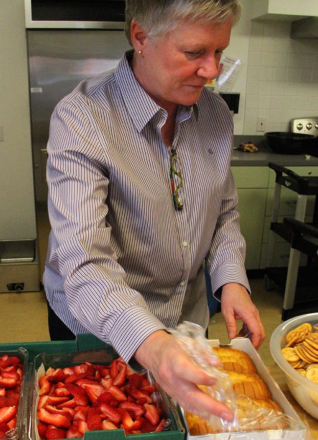 Kathy Osburn prepares meals for seniors at the Ken Edwards Center in May. (Daniel Archuleta daniela@www.smdp.com)