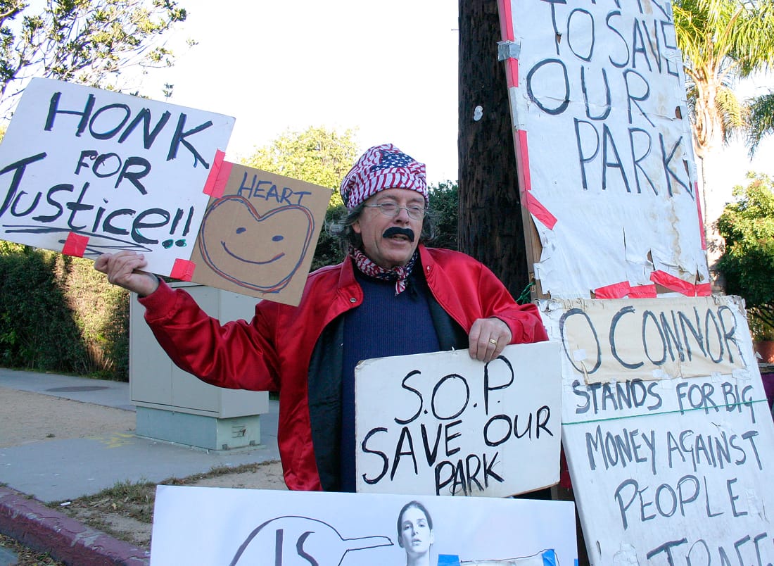 Village Trailer Park resident Peter Naughton protests the closure of the park on Wednesday.  (Photo by Daniel Archuleta)