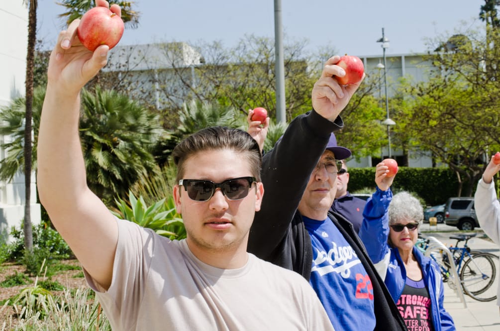 Apples were held up Sunday at City Hall on behalf of Mark Black, a teacher that was placed on leave following an altercation with a pair of Santa Monica High students. (Paul Alvarez Jr. editor@www.smdp.com)