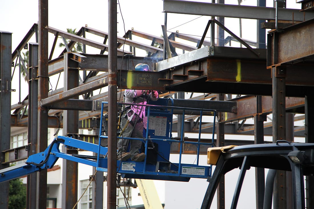 A worker welds at the site of a new building at St. Monica Catholic School. (Photo by Daniel Archuleta)