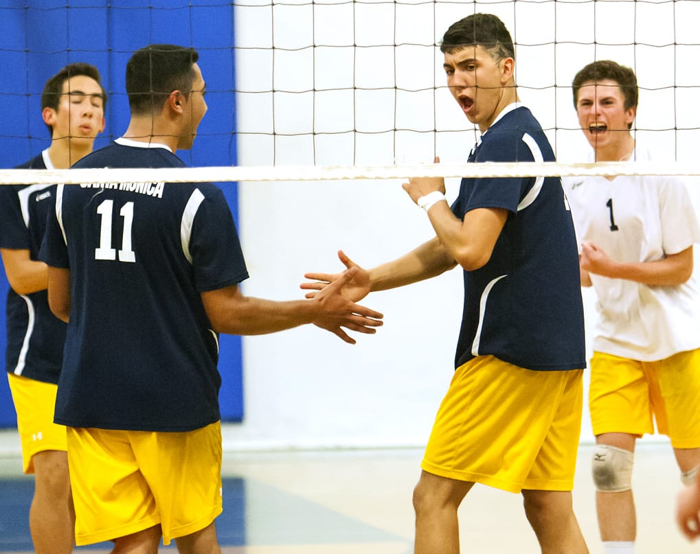 YUP! Isan Contrera (right) of Santa Monica celebrates after scoring a point against the defense of Whittier Christian in the first round of the CIF-Southern Section Division 3 boys' volleyball playoffs at Santa Monica High School on Tuesday. Samohi won in straight sets, 25-18, 25-15, 25-19, to advance to the next round. (Photo by Michael Yanow)