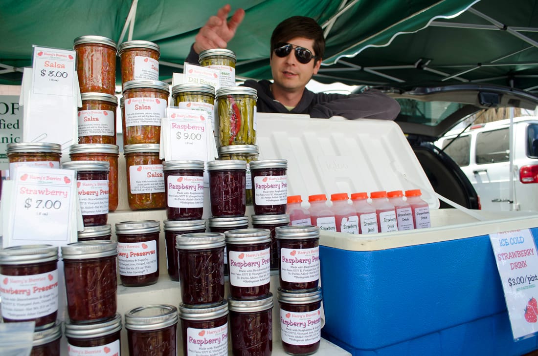 Kris Gean shows off the products he sells at the Downtown Farmers' Market. (Photo by Paul Alvarez Jr.)