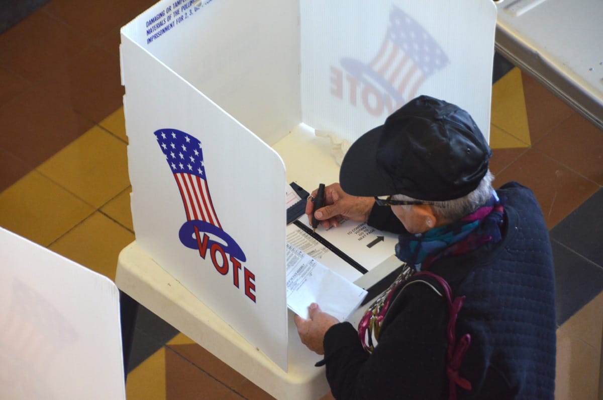 A voter casts a ballot at City Hall on Tuesday. (Fabian Lewkowicz)