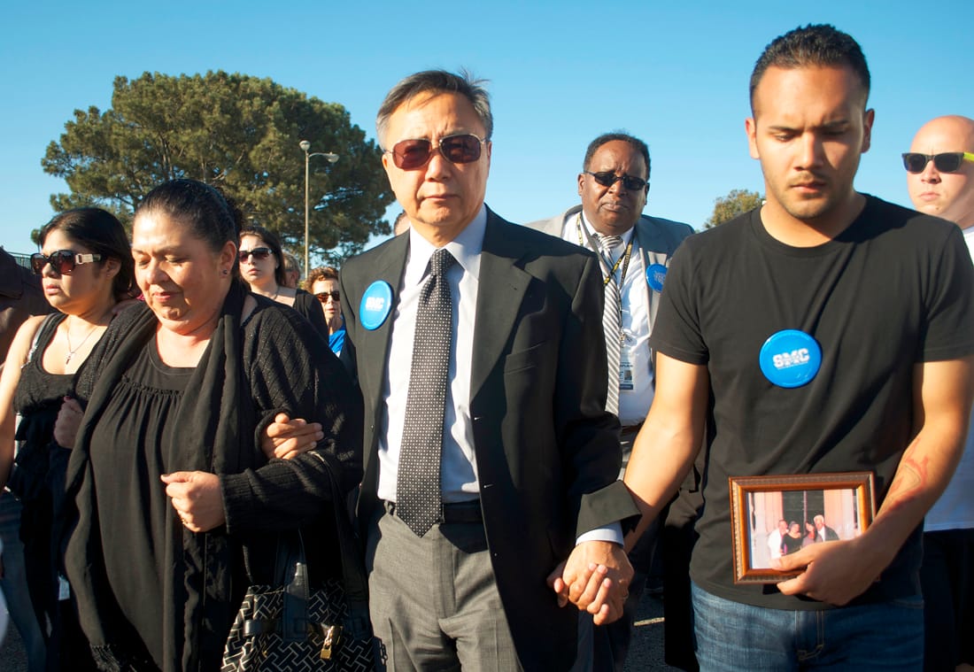 Santa Monica College President Dr. Chui Tsang (center) leads a procession to Corsair Field on Monday as part of a vigil to remember the five victims of Friday's shootings on and near the campus. (Photo by Paul Alvarez Jr.)