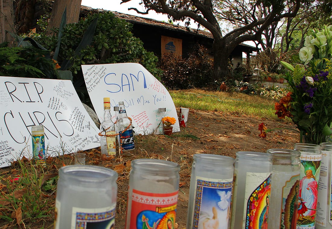 IN TRIBUTE: A memorial has popped up in front of the home where John Zawahri gunned down his father and brother on Friday. (Photo by Daniel Archuleta)