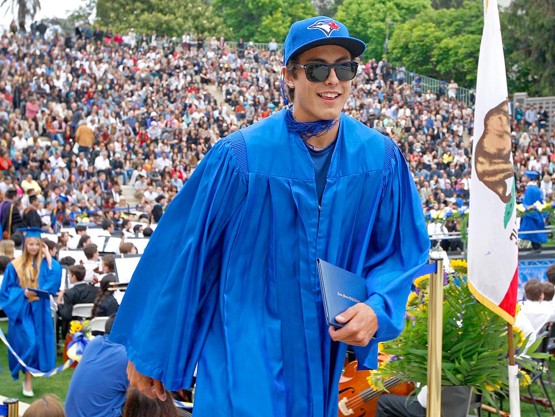 Senior Conner Greene receives his diploma from Santa Monica High School during the school's graduation ceremony at the Memorial Greek Theater last week. (Photo by Michael Yanow)