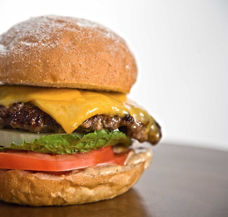 The Burger Lounge in Downtown offers grass-fed beef with organically-grown veggies for a burger with less fat and fewer calories than factory farmed meat. (Photo courtesy Google Images)