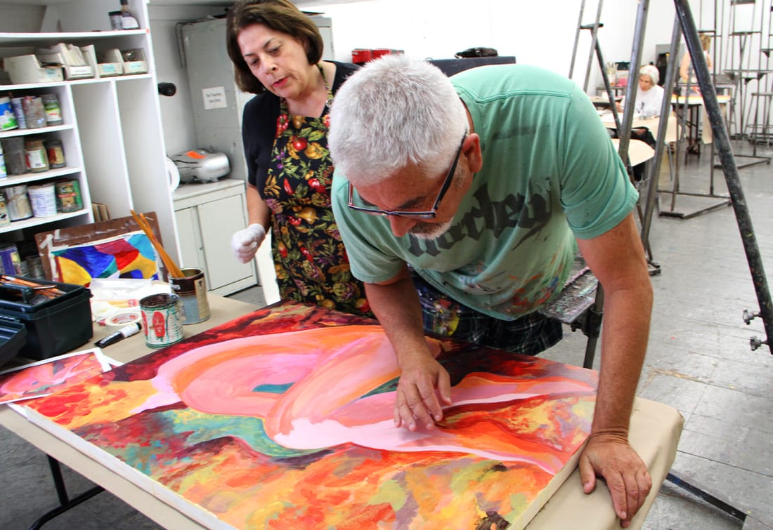 Student Billie Udko (left) looks on as instructor David Lloyd examines her work during an abstract painting class at the Brentwood Art Center on Tuesday. (Photo by Daniel Archuleta)