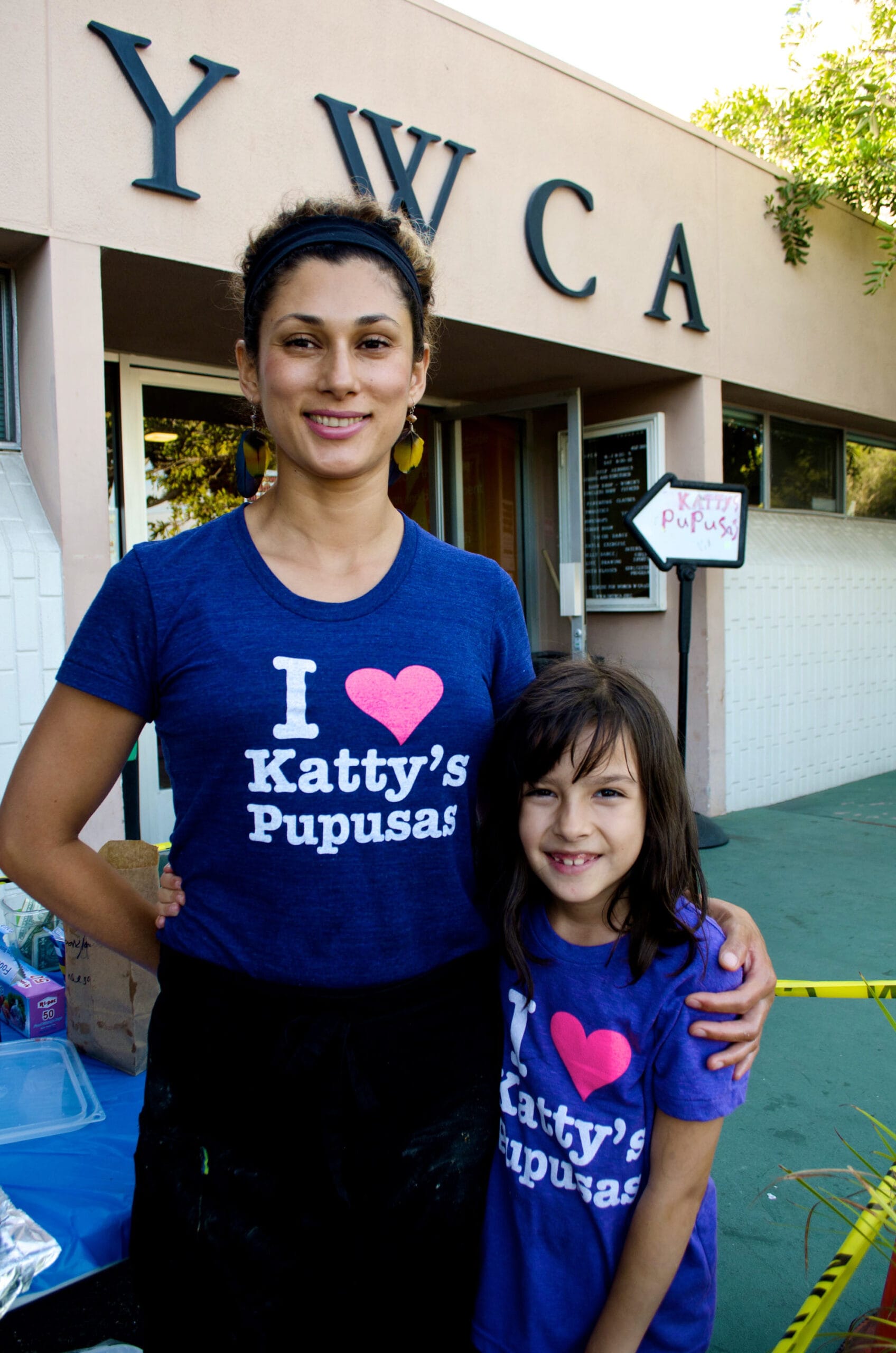 Salinas and her daughter take a break from cooking pupusas. 