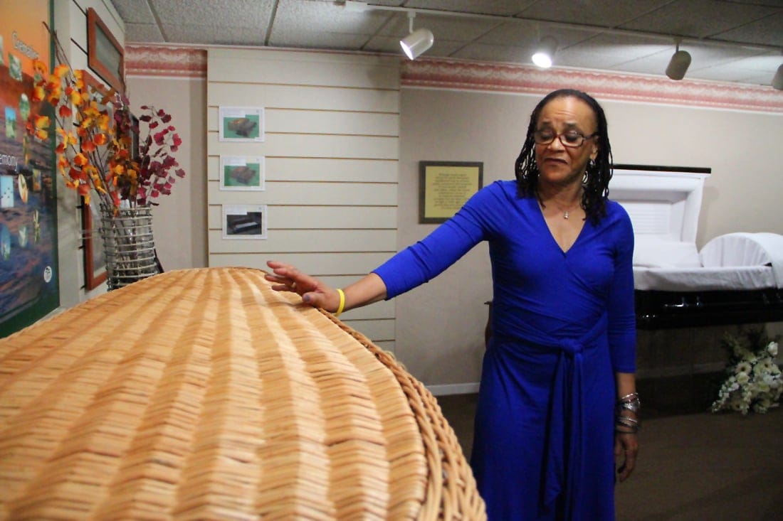 OPTIONS: Annette Smith, with Gates Kingsley & Gates Moeller Murphy Funeral Directors, discusses the benefits of being buried in a wicker casket on Tuesday. She said that the wicker models appeal to people who are concerned about the environment. (Photo by Daniel Archuleta)