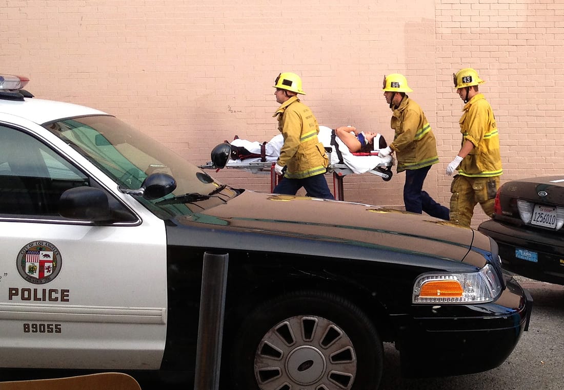 AFTERMATH: Fire personnel whisk a victim away from the scene of a deadly car crash on the Venice boardwalk last Saturday. (Photo courtesy Byron Kennerly)