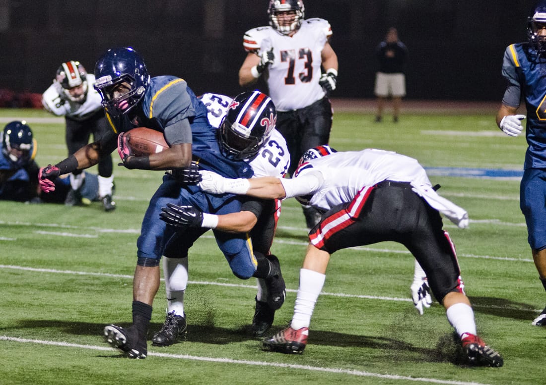 BREAKING TACKLES: Santa Monica High running back Kwame Duggins runs the ball against Hart last Friday. (Paul Alvarez Jr.)
