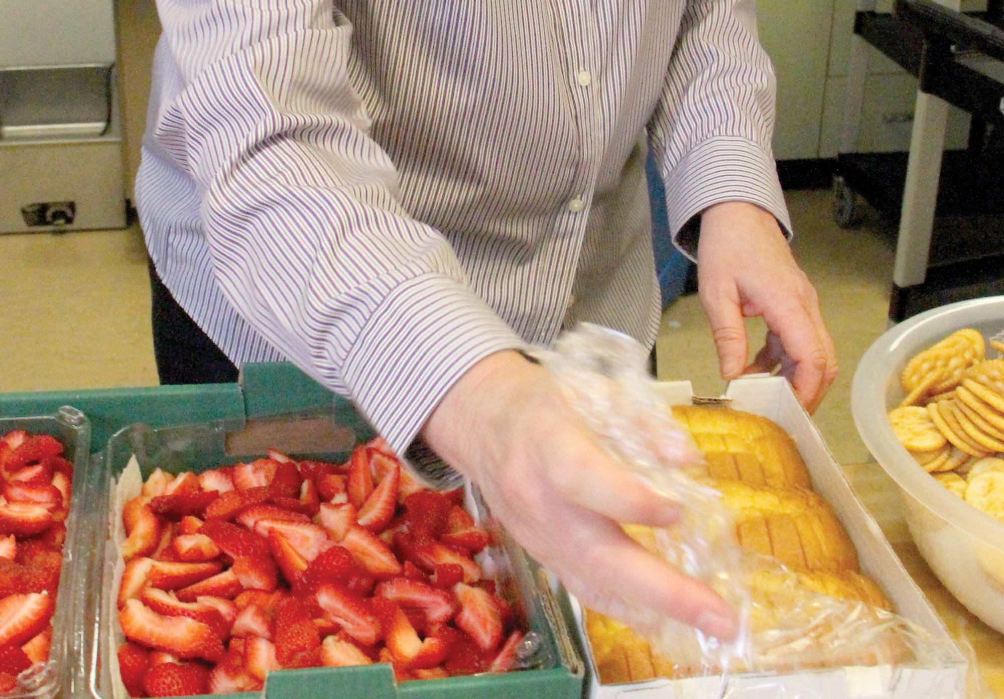 GOOD STUFF: Kathy Osburn prepares meals for seniors at WISE earlier this year. (File photo)
