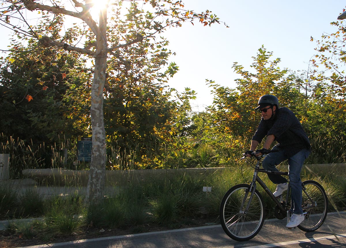 MOVING: Daily Press Editor-in-Chief Kevin Herrera rolls down Main Street on his trusty bike on Wednesday. (Daniel Archuleta daniela@www.smdp.com)