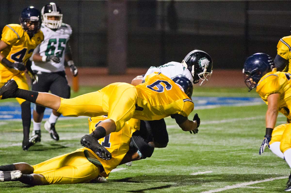 GOT ‘EM: Samohi's Terrence Jackson (center) makes a play against Inglewood earlier this season. He finished with 19 sacks. (Paul Alvarez Jr. editor@www.smdp.com)