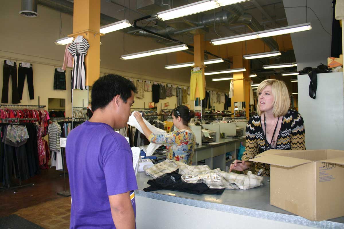 While hiring seems to be showing an uptick and lending to small businesses is improving, 2013 was a rough year for merchants. Here a customer at Crossroads Trading Co. in Downtown tries to sell some of his old clothes. (File photo)