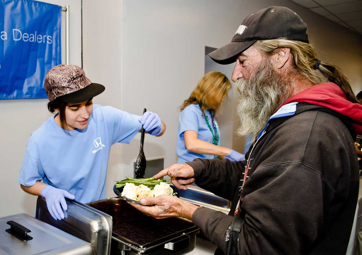 PITCHING IN: Leah Dietrich (left) volunteered during an event to feed the homeless hosted by Honda Motors at the Civic Auditorium on Friday. (Paul Alvarez Jr. editor@www.smdp.com)