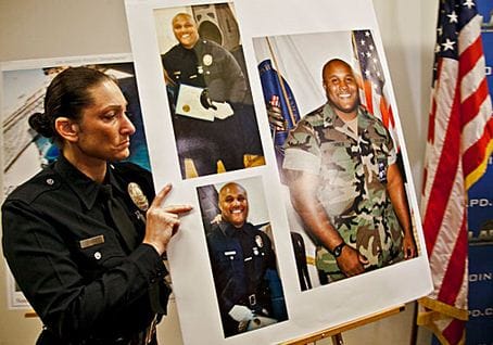 An LAPD officer holds up photos of suspected cop killer Christopher Dorner. (Photo courtesy Google Images)