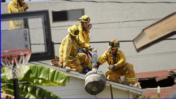 Santa Monica fire fighters remove a steel pipe and concrete that was part of an explosive device detonated in 2011 near Chabad House in Santa Monica. (Photo courtesy Google Images)
