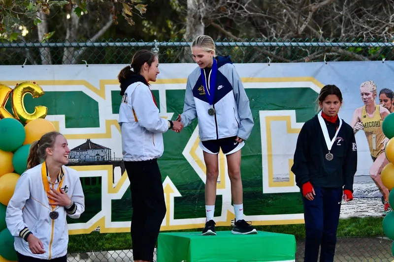 boys varsity cross country team at league finals