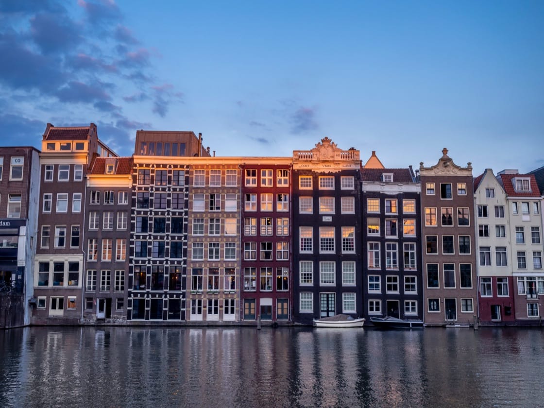 Damrak canal houses at night, Amsterdam