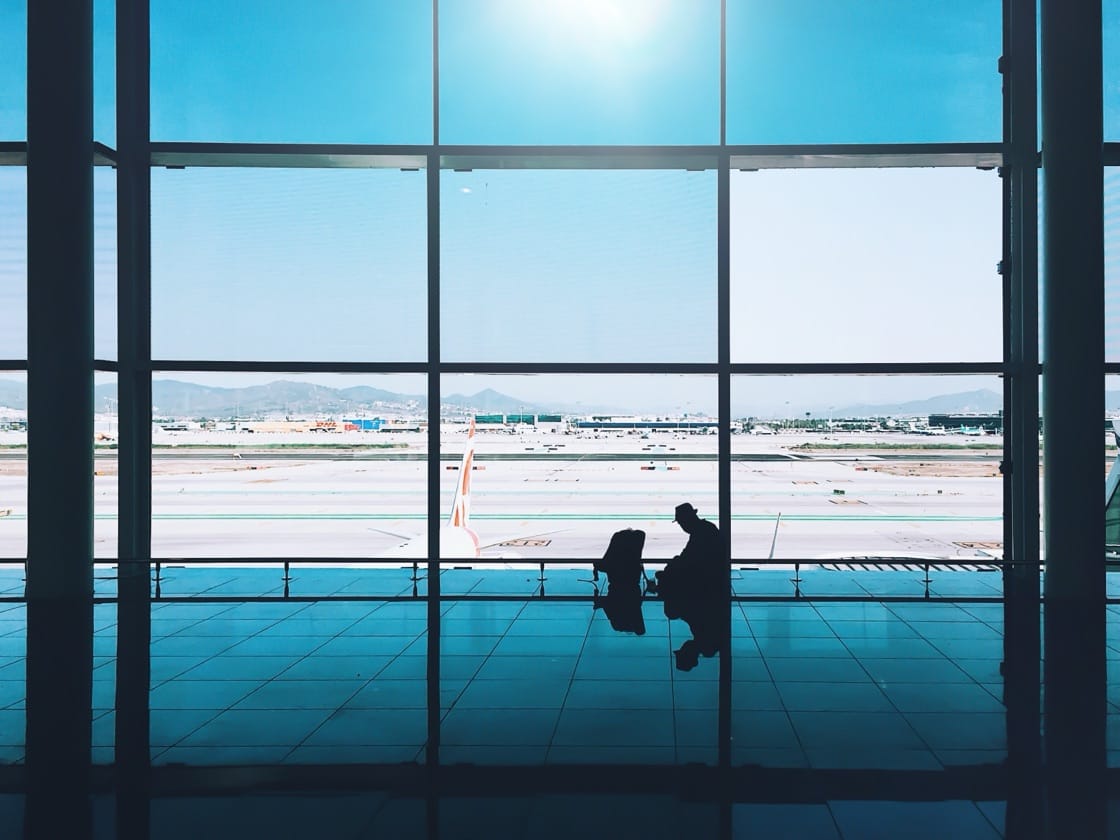 Traveler silhouette at an airport window