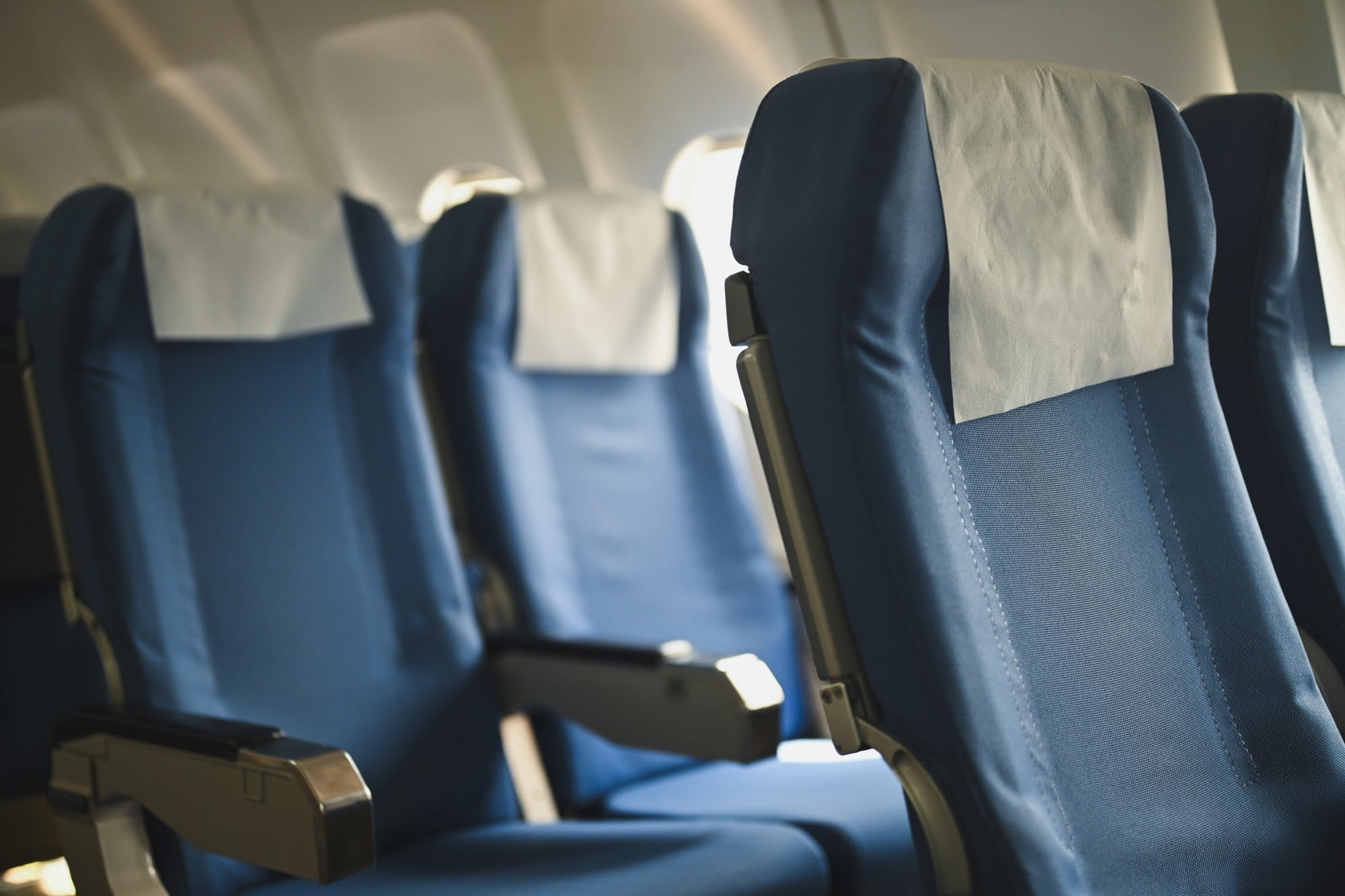 Airplane Interior with Blue Seats and White Headrests
