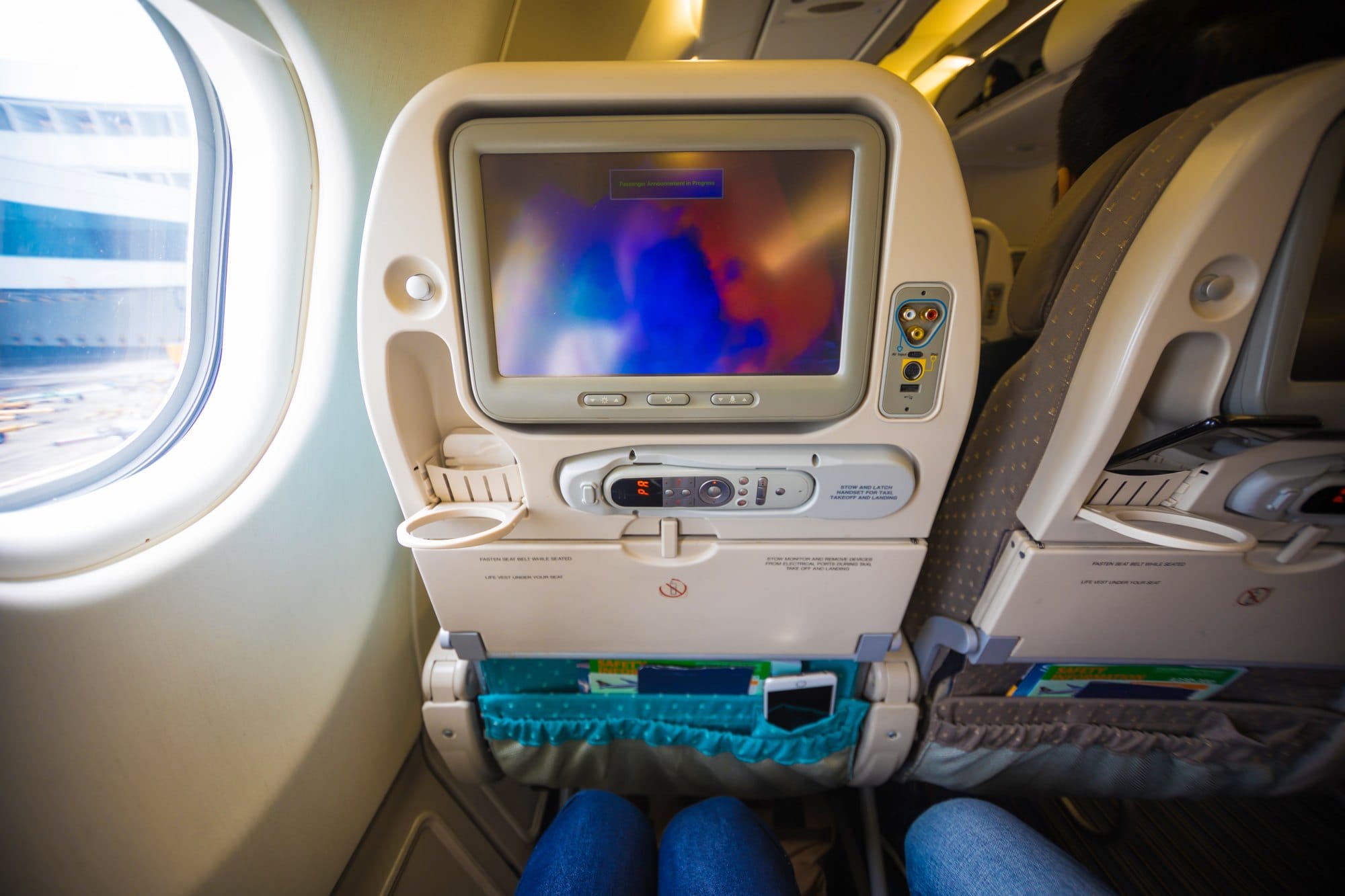Airplane Interior with Entertainment System Near Window