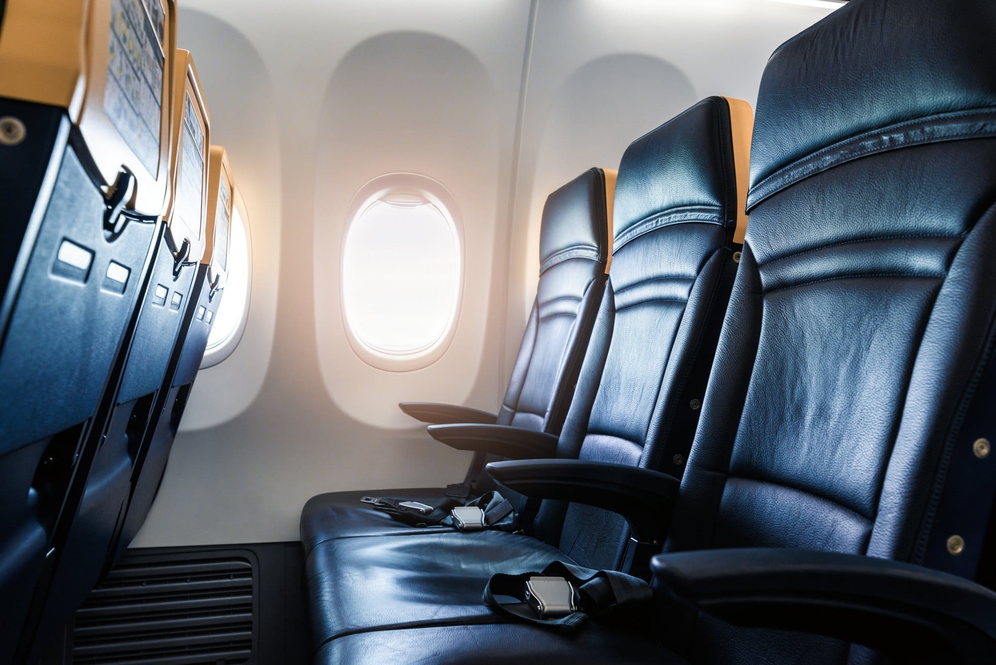 Airplane Interior with Leather Seats and Bright Window