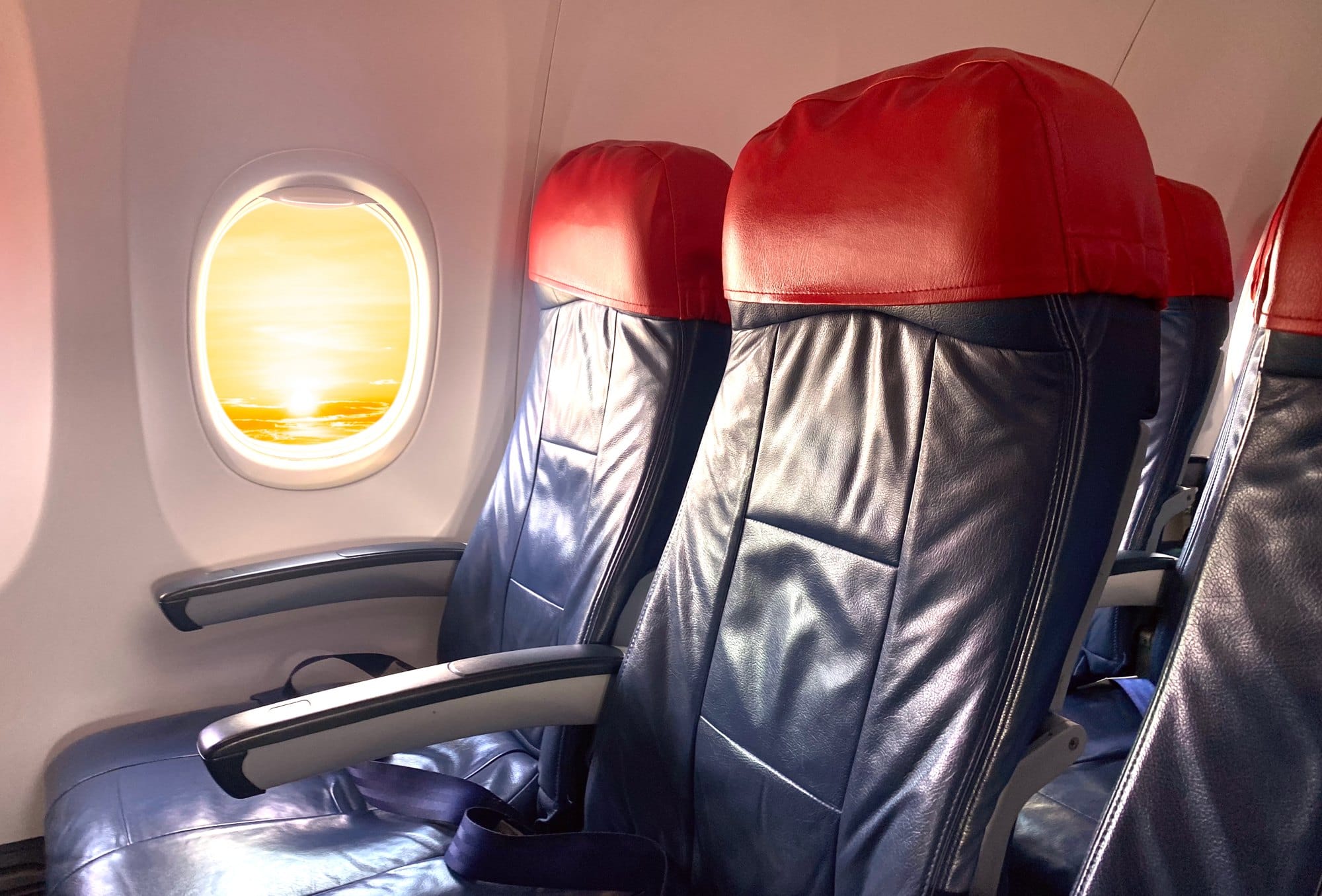Airplane Seats with Bright Sunrise Seen Through Window