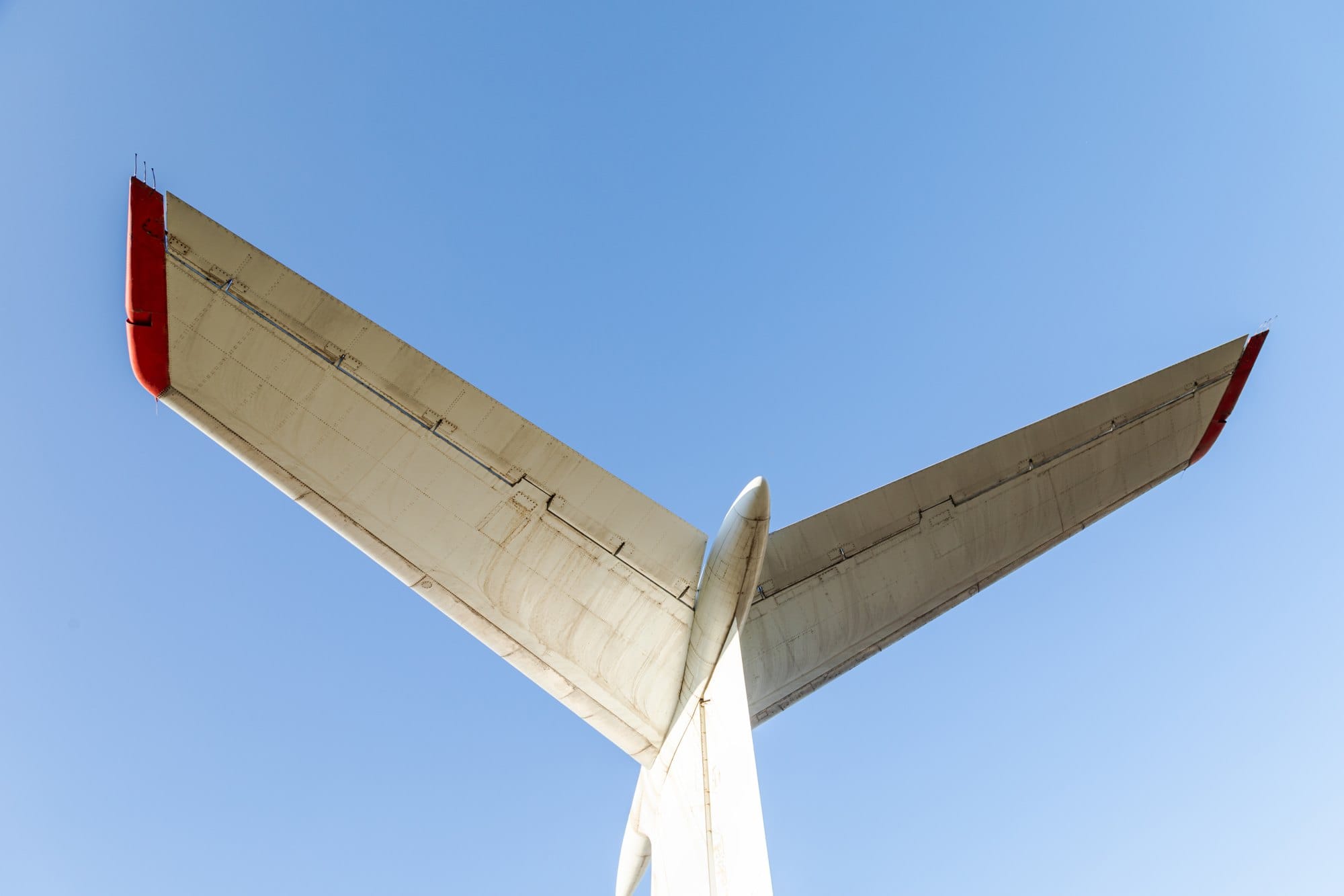 Airplane Tail Fin Against Blue Sky Background