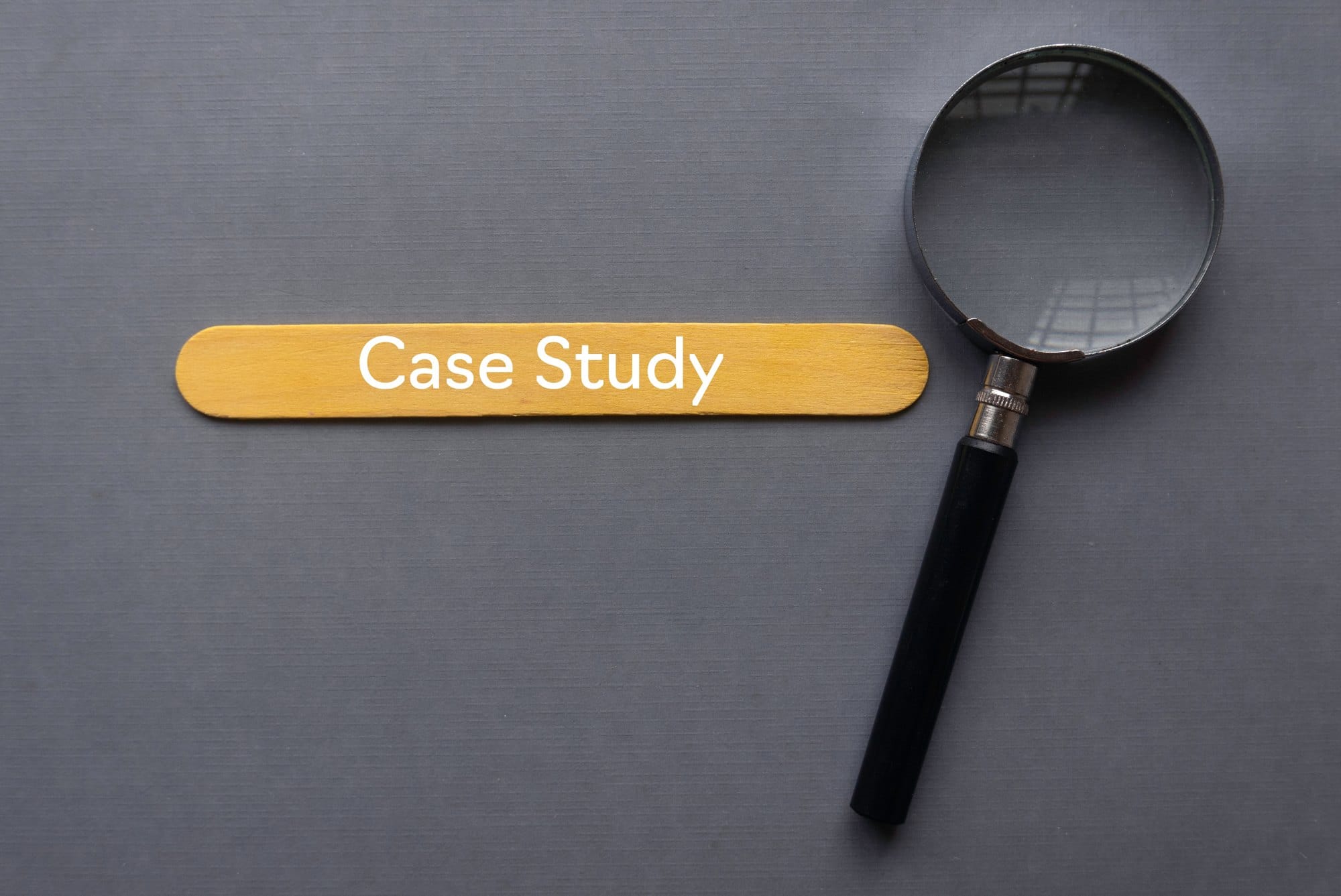 Case Study Concept with Magnifying Glass on Grey