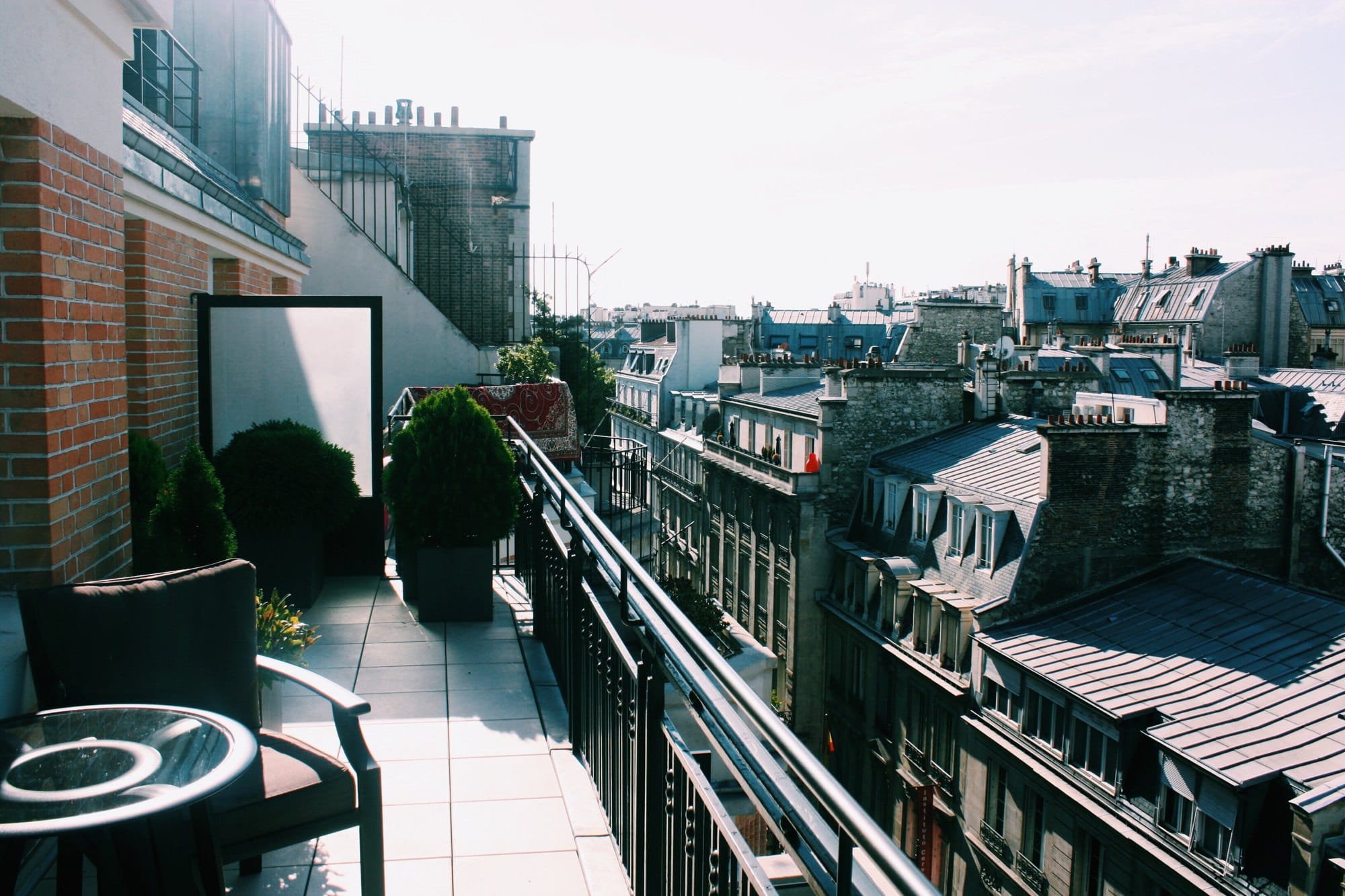 City Rooftops and Balcony Chairs on Bright Day