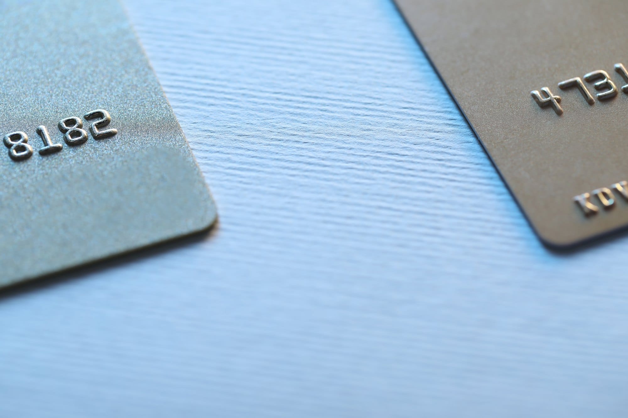 Close-up View of Two Credit Cards on Blue Background