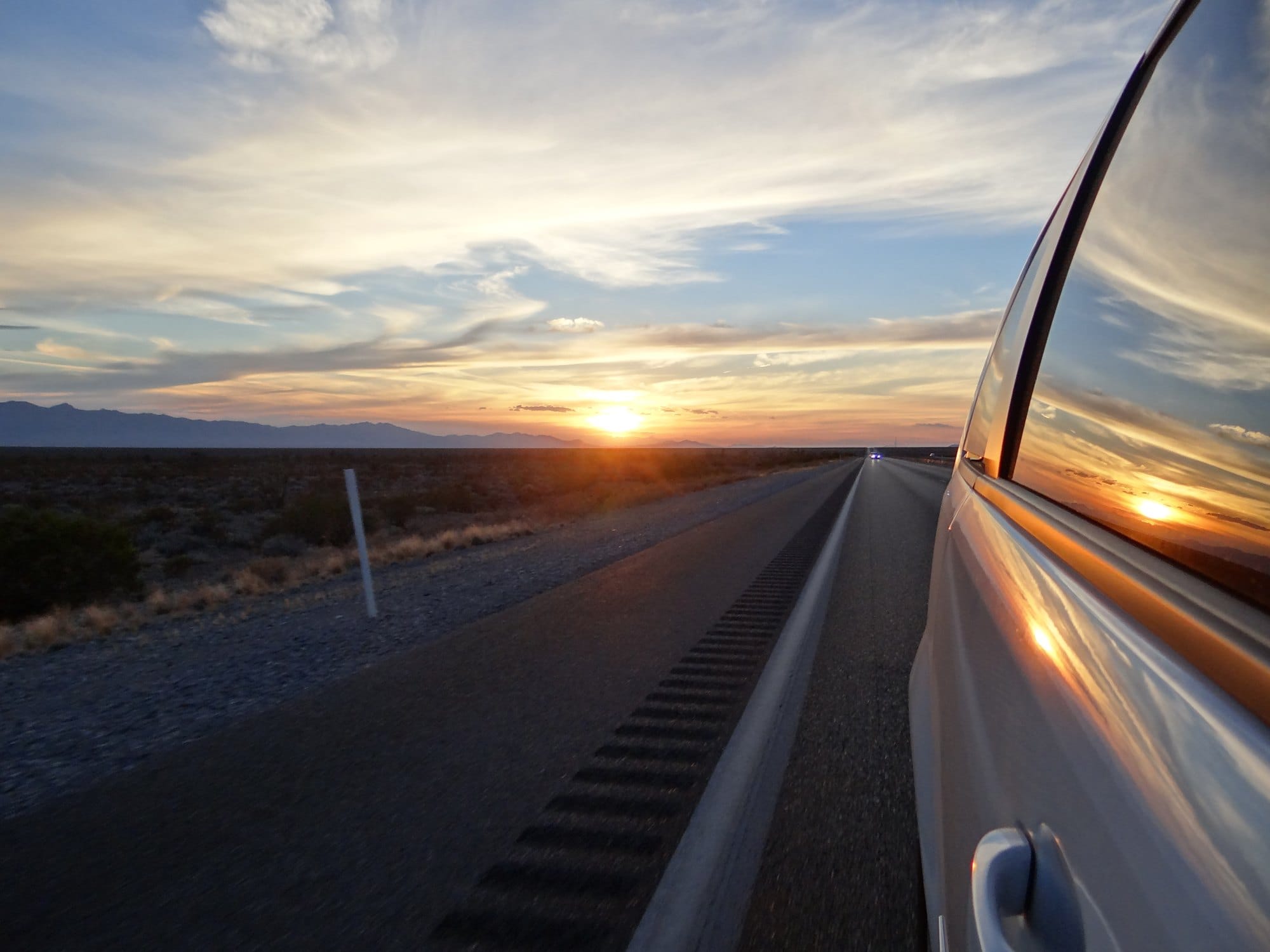 Desert Highway at Sunset with Car Window Reflection