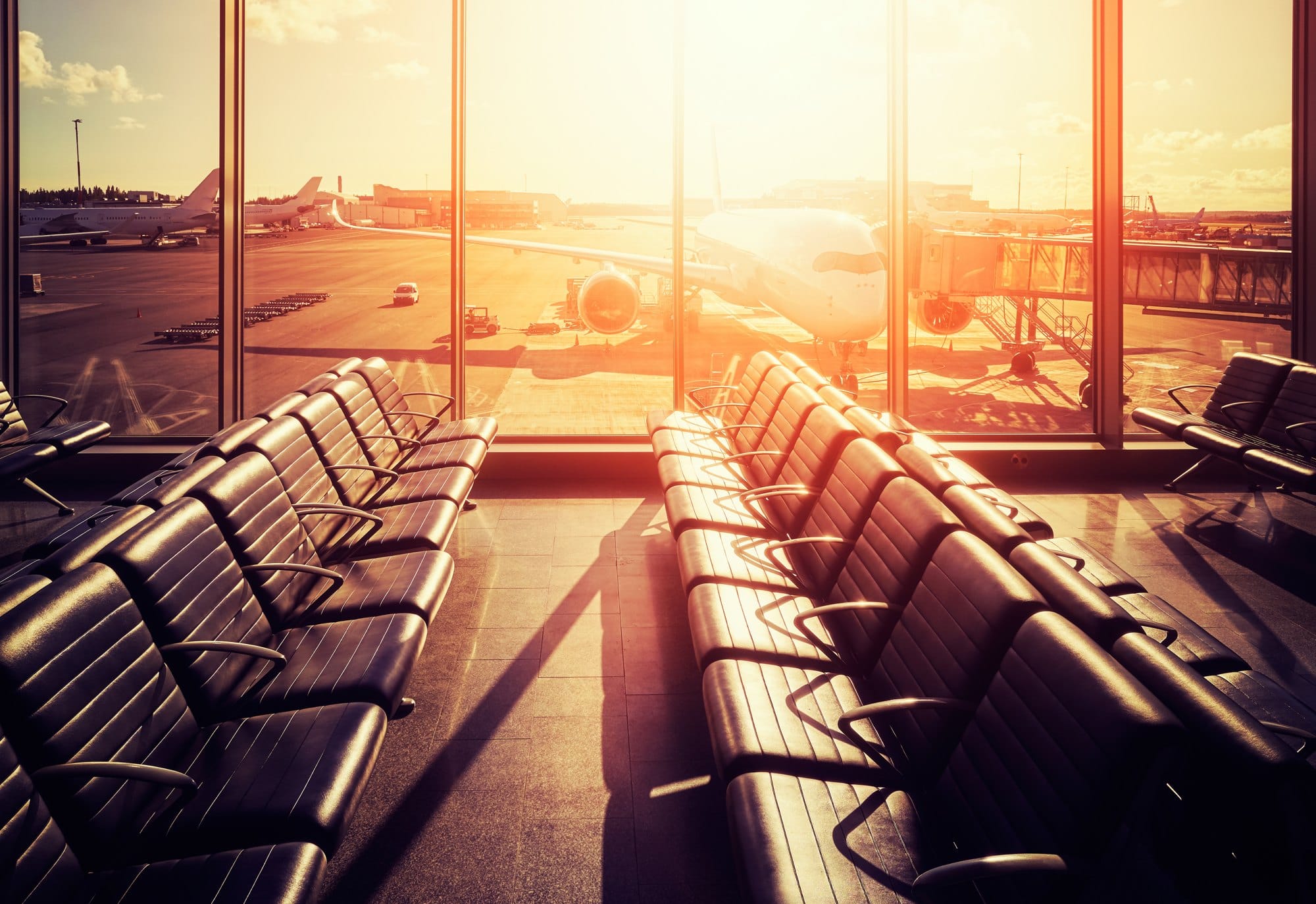 Empty seats in an airport departure hall at sunset