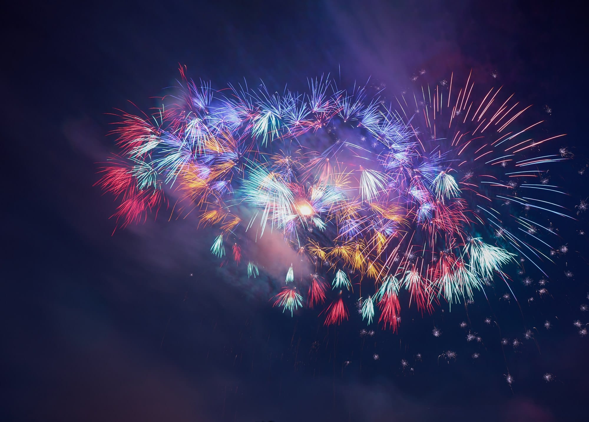 Explosion of Colorful Fireworks Lighting Up Dark Sky