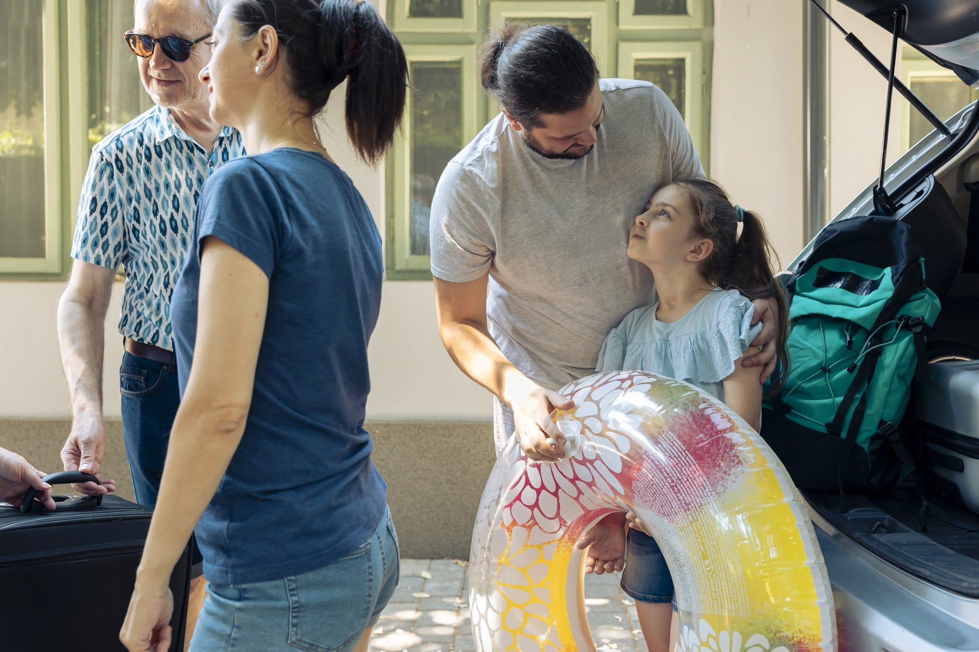 Family Loading Car for Road Trip in Suburbs