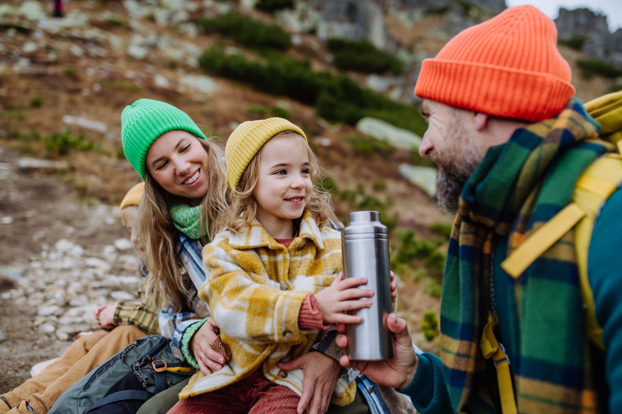 Happy Family Hiking Together on Mountain Trail