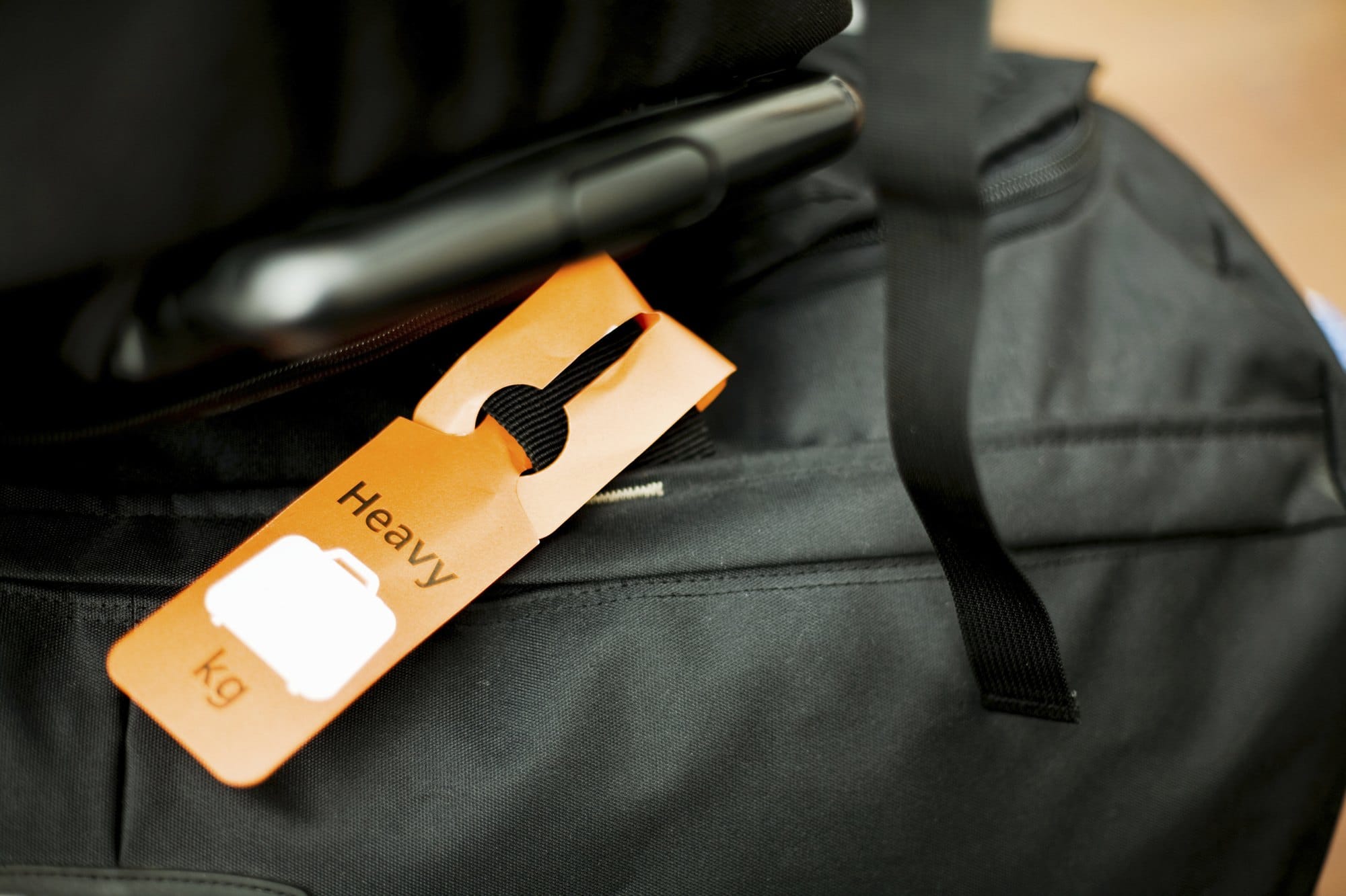 Heavy Luggage Tag Attached to Black Bag