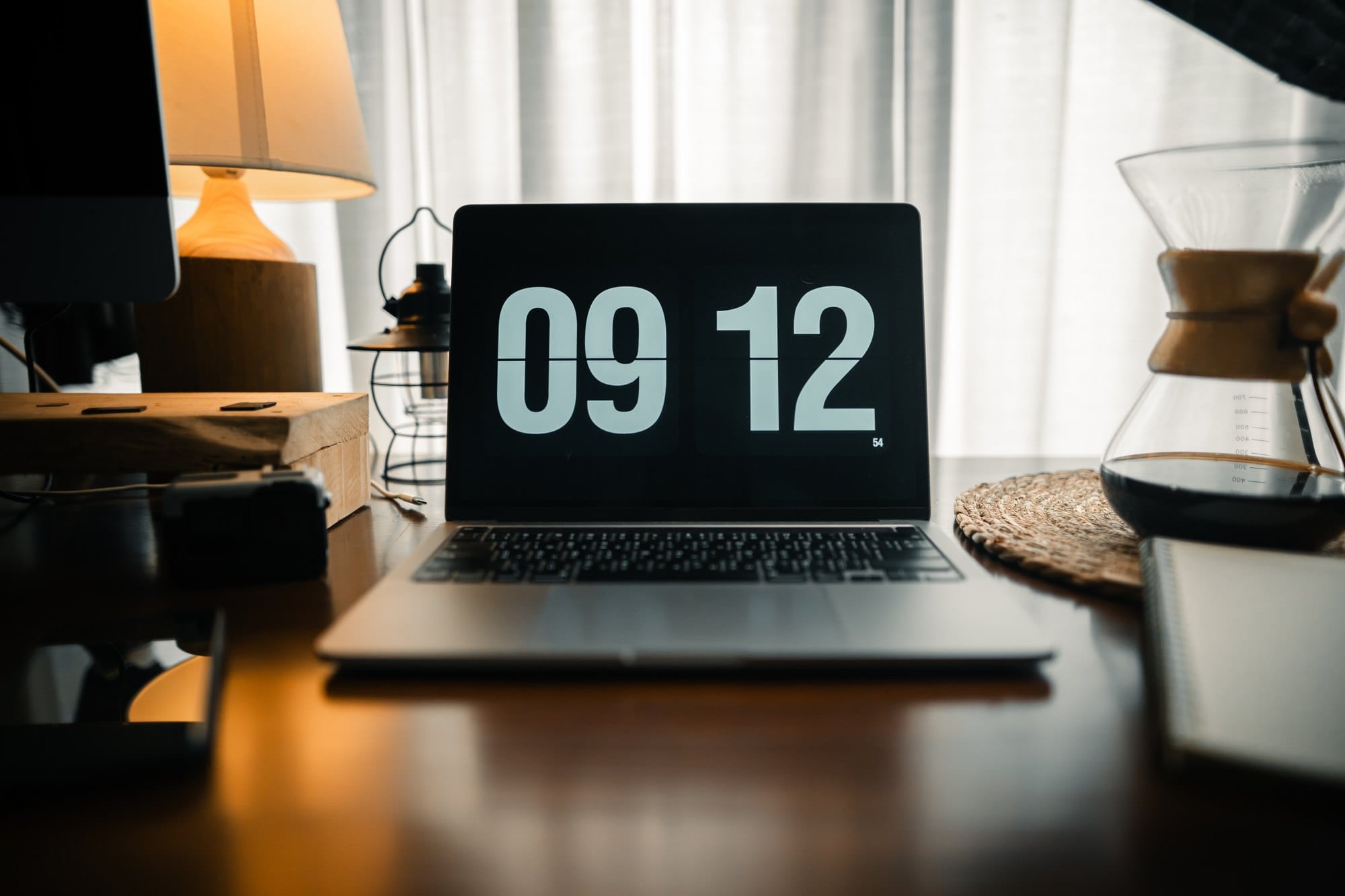 Laptop Showing Digital Time on Desk in Home