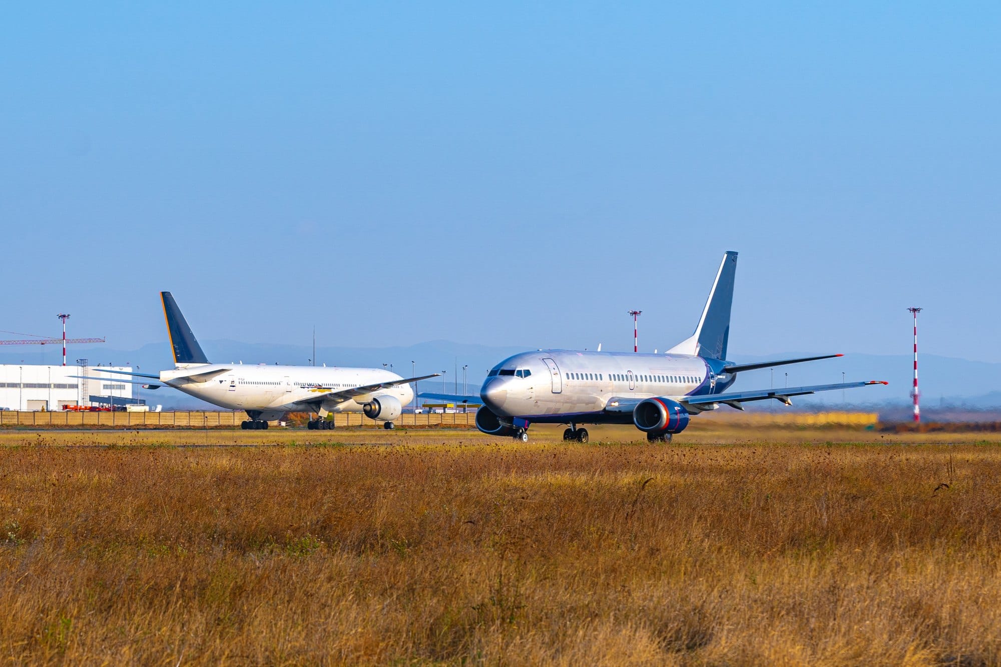 Passenger plane taking off from runway at airport on sunny day