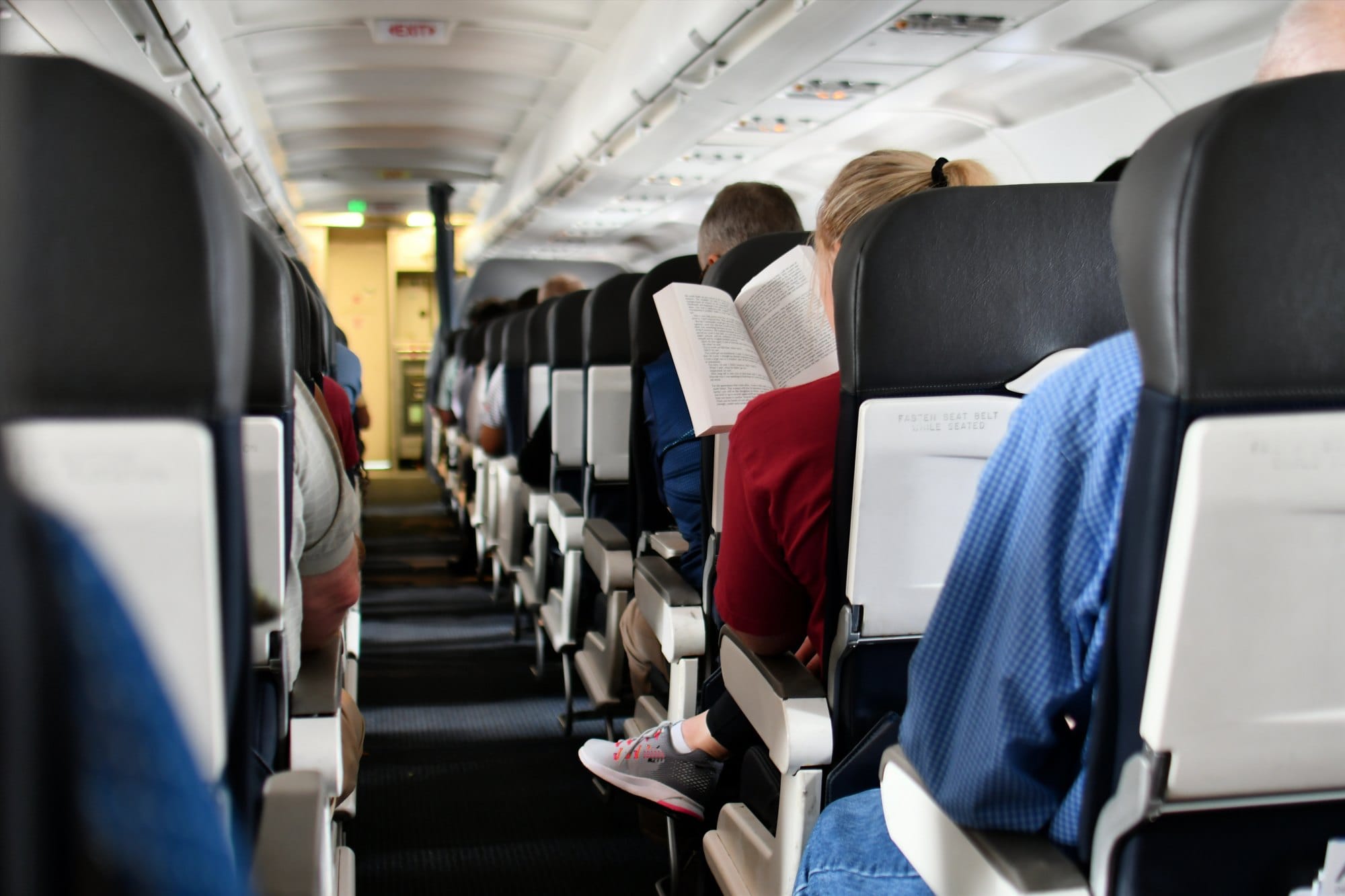 Passengers seated in seats of an airplane cabin